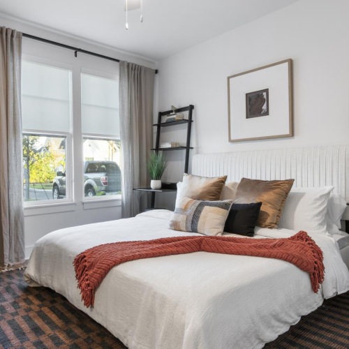a bedroom with a bed and a shelf