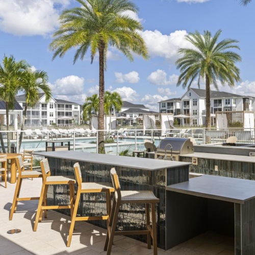 a grill area with tables and chairs